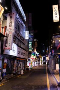 a city street at night with signs on buildings at Hi Stay Jongno in Seoul