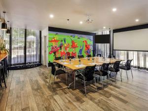 a conference room with a large painting on the wall at Mercure Bendigo Schaller in Bendigo