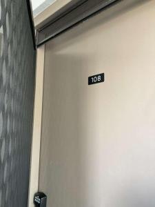 a garage door with a sign that says at Enjoy the sunset at OCEAN FRONT 1BR Apartment - pool on site! in Kailua-Kona