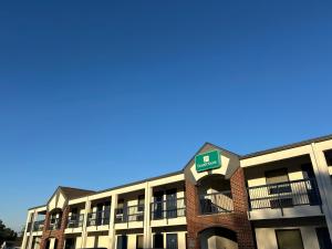 a building with a sign on top of it at GuestHouse Inn Dothan in Dothan