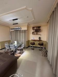 a dining room with a table and chairs at Eden Court Luxe in Ogbojo