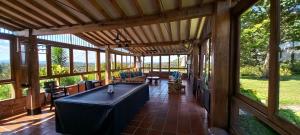a large screened in porch with a table and chairs at Casa de Campo Bheta in Guatapé +26 photos