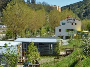 a building with a sign on the side of it at Mobil-home 4 pers. avec terrasse à Puget-Théniers - API-1-52-717 in Puget-Théniers