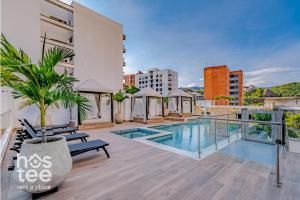 an apartment with a swimming pool on a building at R211 Loft with large balcony, infinity pool and spa in Estación El Salto
