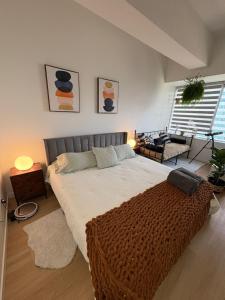 a bedroom with a large bed with a brown blanket at Studio Downtown , Rodgers Views, AC, Heated Free Underground Parking in Edmonton