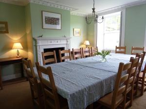 a dining room with a table and chairs and a fireplace at Baysdale Abbey in Battersby