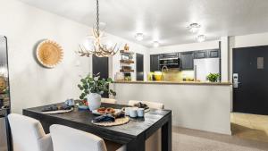 a dining room and kitchen with a table and chairs at Steps from Snowmass Village Fireplace Firepit Mountain Views Aspen Glow Retreat by AvantStay in Snowmass Village +18 photos
