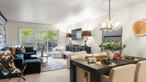 a kitchen and living room with a table and chairs at Steps from Snowmass Village Fireplace Firepit Mountain Views Aspen Glow Retreat by AvantStay in Snowmass Village