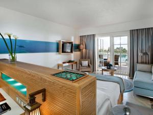 a hotel room with a suite with a swimming pool at Movenpick Resort & Spa El Gouna in Hurghada +107 photos
