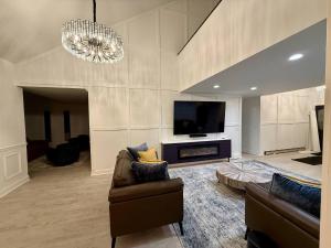 Highland LakesTop Luxe Oasis -Ski, Hike, Firepit, Spa, Golf的客厅里有一张沙发和一台电视