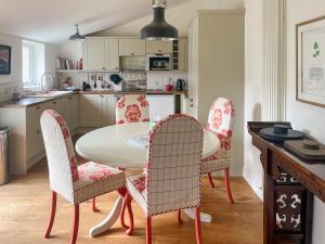a kitchen with a table and chairs in a kitchen at The Byre in Rispond