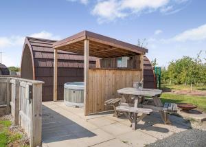 a shed with a table and a picnic table at South View Retreat in Carlton