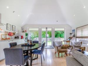 a kitchen and living room with a table and chairs at Fir Tree Apartment - Uk49993 in Crowborough