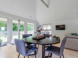 a living room with a table and chairs at Fir Tree Apartment - Uk49993 in Crowborough