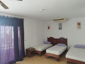 a room with two beds and a window at MARIA HOSTEL FOREIGNERS ONLY-CRISS RESORT-NAAMA BAY-CITY CeNTER in Sharm El Sheikh +12 photos