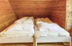 a bed in a room with two pillows at Gorgeous Home In Leinøy With House Sea View in Fosnavåg
