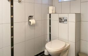 a bathroom with a toilet and a roll of toilet paper at Gorgeous Home In Leinøy With House Sea View in Fosnavåg
