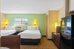 ein Hotelzimmer mit zwei Betten und einem Flachbildfernseher in der Unterkunft GreenTree Suites Eagle / Vail Valley in Eagle + 59 Fotos