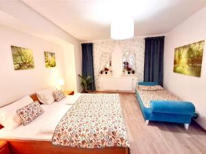 a bedroom with two beds and a blue chair at 2 Rooms Family Apartment Tauchen in Mönichkirchen