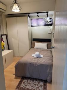 a small bedroom with a bed with a hat on it at Roswad Homestay University Condo Apartment Phase 2 in Kota Kinabalu