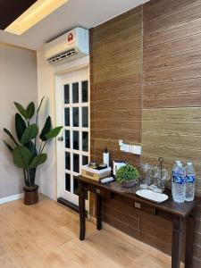 a room with a table with water bottles on it at Roswad Homestay University Condo Apartment Phase 2 in Kota Kinabalu +4 photos