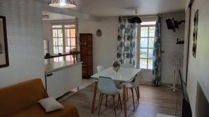 a kitchen and dining room with a table and chairs at Chez Fab & Ketty in Le Moule