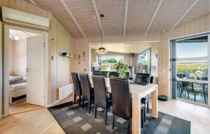 a dining room with a table and chairs at Stunning Home In Tarm With Sauna in Højsand