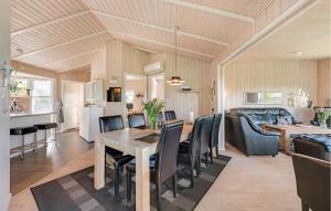 a dining room and living room with a table and chairs at Stunning Home In Tarm With Sauna in Højsand