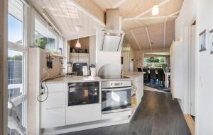 a kitchen with white cabinets and a stove at Stunning Home In Tarm With Sauna in Højsand
