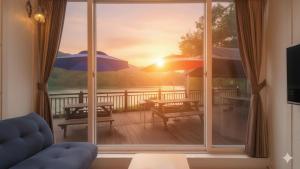a window with a view of a deck with umbrellas at Gapyeong Rialto Pension in Gapyeong