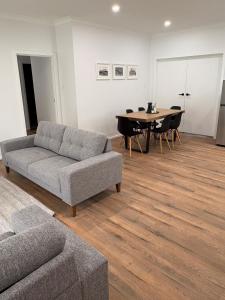 a living room with a couch and a table at The Townhouse in Renmark