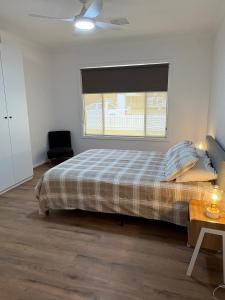 a bedroom with a bed and a window at The Townhouse in Renmark