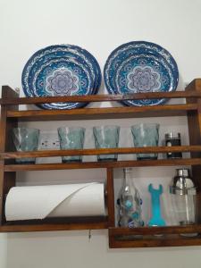 a shelf with plates and dishes on it at Sunzal Refugio Perfecto-3 in El Sunzal +6 photos