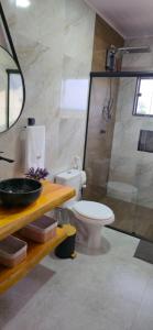 a bathroom with a toilet and a shower at Chalé Pôr do Sol in Cunha +77 photos