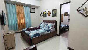 a bedroom with a bed and a mirror at Condo Unit walking distance to Manila Airport (NAIA Terminal 3) in Manila