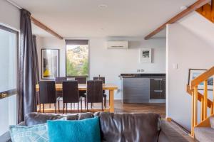 een woonkamer met een bank en een tafel bij The Twins in Queenstown