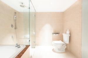 a bathroom with a toilet and a glass shower at Archess Hotel in Taipei +33 photos
