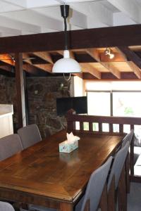 a dining room with a wooden table and chairs at The Cameron Bothy in Queenstown +11 photos