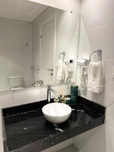 a bathroom with a white sink and a bath tub at Vista al Rio by renty in Encarnación +11 photos