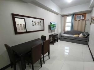 a living room with a black table and a couch at Condo Unit walking distance to Manila Airport (NAIA Terminal 3) in Manila