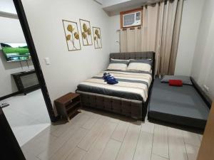 a small bedroom with a bed and a window at Condo Unit walking distance to Manila Airport (NAIA Terminal 3) in Manila +86 photos