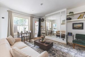 a living room with a couch and a table at Sleeps 5! Parking, WiFi & Parking, 4 Mins To Station, NEWLY REFURBISHED!! in London