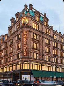 a large building with a clock on top of it at Sleeps 5! Parking, WiFi & Parking, 4 Mins To Station, NEWLY REFURBISHED!! in London