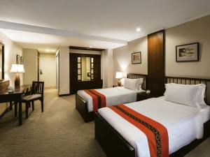 Ένα ή περισσότερα κρεβάτια σε δωμάτιο στο Movenpick Suriwongse Hotel Chiang Mai
