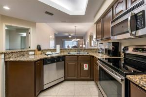 a large kitchen with brown cabinets and appliances at Hilton Vacation Club St Augustine in Saint Augustine