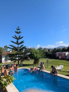 a group of people sitting in a swimming pool at VILLA MARINA 4 in Los Barrios