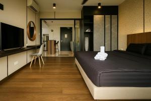 a bedroom with a bed and a television in it at Alma's Suites Luna Studio 2Pax Puteri Harbour by Our Stay in Iskandar Puteri +28 photos