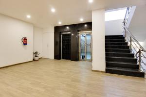 an empty room with a staircase and a door at Super townhouse moosapet Rcc Prime in Hyderabad