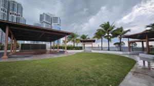 a large grassy area with palm trees and buildings at Alma's Suites Luna Studio 2Pax Puteri Harbour by Our Stay in Iskandar Puteri