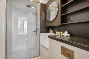 a bathroom with a shower and a sink and a mirror at Luxury Indoor Pool, Jacuzzi, Sauna and Steam in Melbourne +13 photos